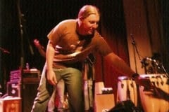 Derek handing me his broken string